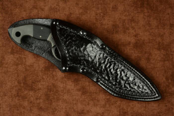 "Ari B'Lilah" Counterterrorism Tactical Knife, leather sheathed view in T3 cryogenically treated CPM 154CM powder metal technology high molybdenum martensitic stainless steel blade, 304 stainless steel bolsters, Black G10 fiberglass/epoxy composite handle, hybrid tension tab-locking sheath in kydex, anodized aluminum, stainless steel, titanium