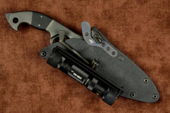 "Ari B'Lilah" Counterterrorism Tactical Knife, sheathed view with HULA flashlight accessory in T3 cryogenically treated CPM 154CM powder metal technology high molybdenum martensitic stainless steel blade, 304 stainless steel bolsters, Black G10 fiberglass/epoxy composite handle, hybrid tension tab-locking sheath in kydex, anodized aluminum, stainless steel, titanium
