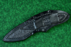 "Ari B'Lilah" Counterterrorism Tactical Knife, leather sheathed view, back side, in T3 cryogenically treated CPM 154CM powder metal technology high molybdenum martensitic stainless steel blade, 304 stainless steel bolsters, Black/Red G10 fiberglass/epoxy composite handle, hybrid tension tab-locking sheath in kydex, anodized aluminum, stainless steel, titanium