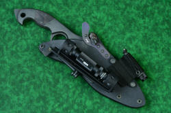 "Ari B'Lilah" Counterterrorism Tactical Knife, sheathed view with HULA and LIMA accessories, in T3 cryogenically treated CPM 154CM powder metal technology high molybdenum martensitic stainless steel blade, 304 stainless steel bolsters, Black/Red G10 fiberglass/epoxy composite handle, hybrid tension tab-locking sheath in kydex, anodized aluminum, stainless steel, titanium