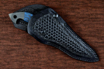 "Ari B'Lilah" counterterrorism, tactical, combat knife, sheathed view in T4 cryogenically treated 440C high chromium martensitic stainless steel blade, 304 stainless steel bolsters, blue/black tortoiseshell G10, black micarta  handle, post-lock leather sheath in 9-10 oz. shoulder, double row nylon stitching, black oxide stainless steel snaps and reinforcement hardware