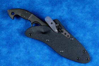 "Ari B'Lilah" counterterrorism, tactical, combat knife, sheathed view in T4 cryogenically treated 440C high chromium martensitic stainless steel blade, 304 stainless steel bolsters, carbon fiber handle, hybrid tension tab locking sheath in kydex, anodized aluminum, anodized titanium, black oxide stainless steel