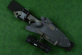 "Ari B'Lilah" counterterrorism, tactical, combat knife, sheathed view with HULA accessory in UBLX mount in T4 cryogenically treated 440C high chromium martensitic stainless steel blade, 304 stainless steel bolsters, red/black  G10 handle, hybrid tension tab locking sheath in kydex, anodized aluminum, anodized titanium, black oxide stainless steel