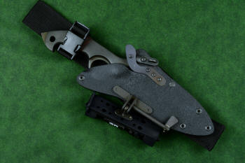 "Ari B'Lilah" counterterrorism, tactical, combat knife, sheathed view with HULA accessory in UBLX mount in T4 cryogenically treated 440C high chromium martensitic stainless steel blade, 304 stainless steel bolsters, red/black  G10 handle, hybrid tension tab locking sheath in kydex, anodized aluminum, anodized titanium, black oxide stainless steel