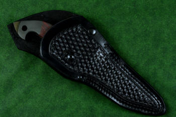 "Ari B'Lilah" counterterrorism, tactical, combat knife, sheathed view in T4 cryogenically treated 440C high chromium martensitic stainless steel blade, 304 stainless steel bolsters, red/black  G10 handle, 9-10 oz. leather shoulder sheath with nylon double row stitching, black oxide stainless steel snaps and reinforcement