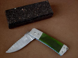 "Aries" in half-open position. Deep hollow grind in etched stainless steel damascus blade with Pounamu New Zealand Green Nephrite Jade gemstone knife handle