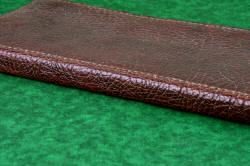 "Bordeaux and Rebanador" fine chef's knives, BBQ knives, book case exterior spine detail in Bison (American Buffalo) skin, heavy leather shoulder, nylon stitching, stainless steel hardware