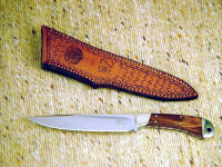 "Buckhorn" Caping, boning knife in 440C high chromium stainless steel blade, nickel silver bolsters, Goncalo Alves hardwood handle, engraved, hand-stamped leather sheath