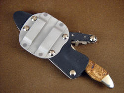 "Callisto" sheath back with conversion plate, allowing horizontal belt wear. It looks large in this photo, but widest point is only 3.125" . Die formed belt loops are solidly riveted to plate.