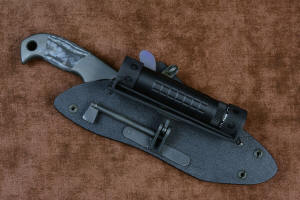 "Contego" Counterterrorism Tactical Knife, sheathed view with HULA mounted, in T3 cryogenically treated CPM154CM  powder metal technology high molybdenum martensitic stainless steel blade, 304 stainless steel bolsters, Black/Gray G10 fiberglass/epoxy composite handle, hybrid tension tab-locking sheath in kydex, anodized aluminum, stainless steel, titanium