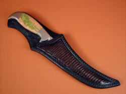 "Cybele" sheathed view. Sheath protects the blade edge and point, and displays bright Unakite handle. Lizard panels are full and slick, inlaid in front and back