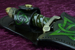 "Darach" celtic dagger, sheathed view, retaining strap detail. Hand-carved, hand-dyed leather throughout