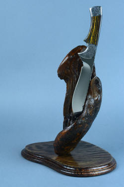 "Golden Eagle" knife and stand view. Deep hollow grind is bold with a mirror finish 