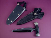 "Grim Reaper" push dagger, obverse side view in blued O1 high carbon tungsten-vanadium tool steel blade, hand-engraved nickel silver bolsters, Australian Black Jade gemstone handle, stingray inlaid in hand-carved leather sheath, kydex, aluminum, nickel plated steel sheath