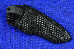"Krag" tactical, counterterrorism professional knife, sheathed view, leather sheath. Sheath is deep and protective, high backed, yet allows enough handle for unsheathing and access to large lanyard hole