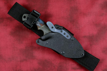 "Krag" tactical, counterterrorism, crossover knife, sheathed view with UBLX in ATS-34 high molybdenum martensitic stainless steel blade, 304 stainless steel bolsters, multicolored tortoiseshell  G10 fiberglass/epoxy composite handle, hybrid tension tab-locking sheath in kydex, anodized aluminum, black oxide stainless steel and anodized titanium