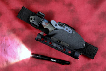 "Krag" tactical, counterterrorism, crossover knife, sheathed, UBLX, HULA view in ATS-34 high molybdenum martensitic stainless steel blade, 304 stainless steel bolsters, multicolored tortoiseshell  G10 fiberglass/epoxy composite handle, hybrid tension tab-locking sheath in kydex, anodized aluminum, black oxide stainless steel and anodized titanium