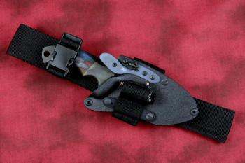 "Krag" tactical, counterterrorism, crossover knife, sheathed view with UBLX and LIMA in ATS-34 high molybdenum martensitic stainless steel blade, 304 stainless steel bolsters, multicolored tortoiseshell  G10 fiberglass/epoxy composite handle, hybrid tension tab-locking sheath in kydex, anodized aluminum, black oxide stainless steel and anodized titanium