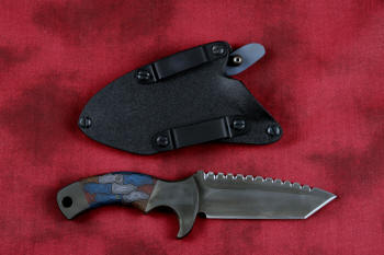 "Krag" tactical, counterterrorism, crossover knife, reverse side view in ATS-34 high molybdenum martensitic stainless steel blade, 304 stainless steel bolsters, multicolored tortoiseshell  G10 fiberglass/epoxy composite handle, hybrid tension tab-locking sheath in kydex, anodized aluminum, black oxide stainless steel and anodized titanium