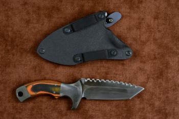"Krag" tactical, counterterrorism, crossover knife, reverse side view in T4 cryogenically treated 440C high chromium martensitic stainless steel blade, 304 stainless steel bolsters, Orange and Black  G10 fiberglass/epoxy composite handle, hybrid tension tab-locking sheath in kydex, anodized aluminum, black oxide stainless steel and anodized titanium