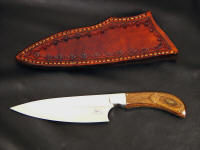 "La Cocina" chef's, kitchen, knife obverse side view in 440C high chromium stainless steel blade, 304 stainless steel bolsters, Dymondwood (stabilized birch laminate) handle, hand-stamped leather sheath