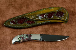 "Lacerta" reverse side view (with reflector above), in deep cryogenically treated O1 tungsten-vanadium tool steel blade, hot blued, 304 stainless steel bolsters, Eudialite gemstone handle, sheath of hand-carved leather inlaid with Ostrich leg skin