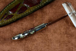 "Lacerta" inside handle tang view (with reflector above), in deep cryogenically treated O1 tungsten-vanadium tool steel blade, hot blued, 304 stainless steel bolsters, Eudialite gemstone handle, sheath of hand-carved leather inlaid with Ostrich leg skin