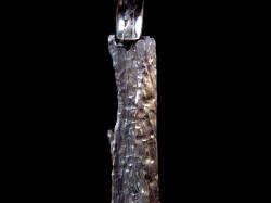 "Morta" knife resting in cast bronze sculptural knife stand