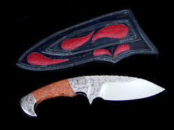 "Ocate" fine skinning, field dressing knife, reverse side view. Sheath back has multiple inlays of stingray skin in tough hand-carved leather shoulder