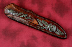 "Opere" sheath back and belt loop view in 440C high chromium martensitic stainless steel blade, 304 stainless steel bolsters, Bay of Fundy Fossilized Agate gemstone handle, frog skin inlaid in hand-carved leather sheath