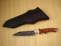 "Quark" utility knife, obverse side view in blued O1 high carbon tungsten-vanadium tool steel blade, nickel silver bolsters, Honduras Rosewood hardwood handle, hand-tooled basket weave leather sheath