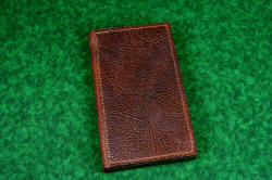 "Steak Knives" book type of storage case, covered in American Buffalo (Bison) skin, stitched with brown nylon