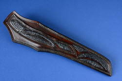 "Taibhse" sheath back view. Sheath is hand-carved and inlaid with multiple curves of black Emu skin in chestnut leather, hand-stitched with brown polyester