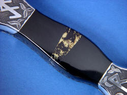 "Vesta" black rune dagger, obverse side view, handle detail. Black Australian Jade is very hard and tough, flanking mosaic of black shale with pyrite (Apache gold) gemstone