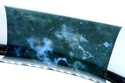 Enlargement and detail of hard polished Indian Green Moss Agate gemstone handle of "Zeta" fine handmade custom knife in T3 cryogenically treated ATS-34 high molybdenum stainless steel blade, 304 stainless steel bolsters, Indian Green Moss Agate gemstone handle, hand-carved leather sheath inlaid with green rayskin