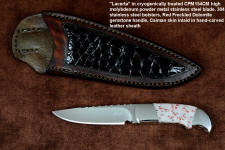 "Lacerta" fine handmade knife, obverse side view in CPM154CM powder metal technology stainless steel blade, 304 stainless steel bolsters, Red Freckled Dolomite gemstone handle, hand-carved leather sheath inlaid with Caiman skin