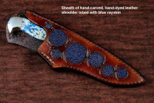 "Andromeda" sheathed view in T3 deep cryogenically treated CPM 154CM powder metal technology high molybdenum stainless steel blade, 304 stainless steel bolsters, K2 Azurite Granite gemstone handle, hand-carved leather sheath inlaid with blue rayskin