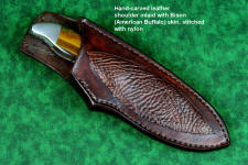 "Arcas" fine custom handmade knife, obverse side view in cryogenically treated 440C high chromum stainless steel blade, blue tiger eye gemstone handle, 304 stainless steel bolsters, American Buffalo (Bison) skin inlaid leather sheath