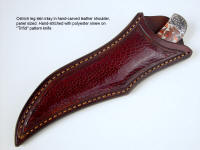 The sheath for this "Trifid" has large panel inlays of burgundy glazed ostrich leg skin in heavy leather shoulder. 