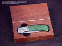 "Gemini" linerlock folding knife in custom case of American Black Walnut. Note finger cutouts to remove knife